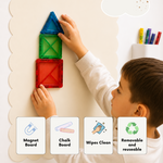 A child's hands and partial body are shown interacting with a magnetic chalkboard wall system, placing a blue triangle magnet on top of stacked red and green square magnets. The wall has a cream-colored scalloped chalkboard surface.
