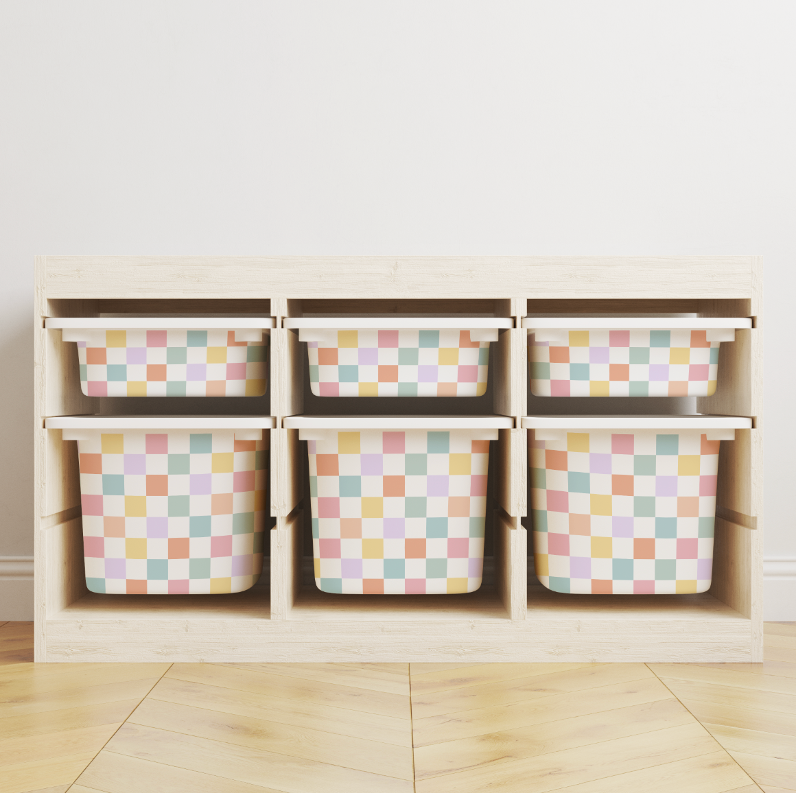 A light wood storage organizer with six cubby shelves holding six pastel checkered bins, set against a plain white wall and light wood floor.