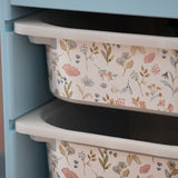 Floral-patterned storage bins stacked against a light blue cabinet.
