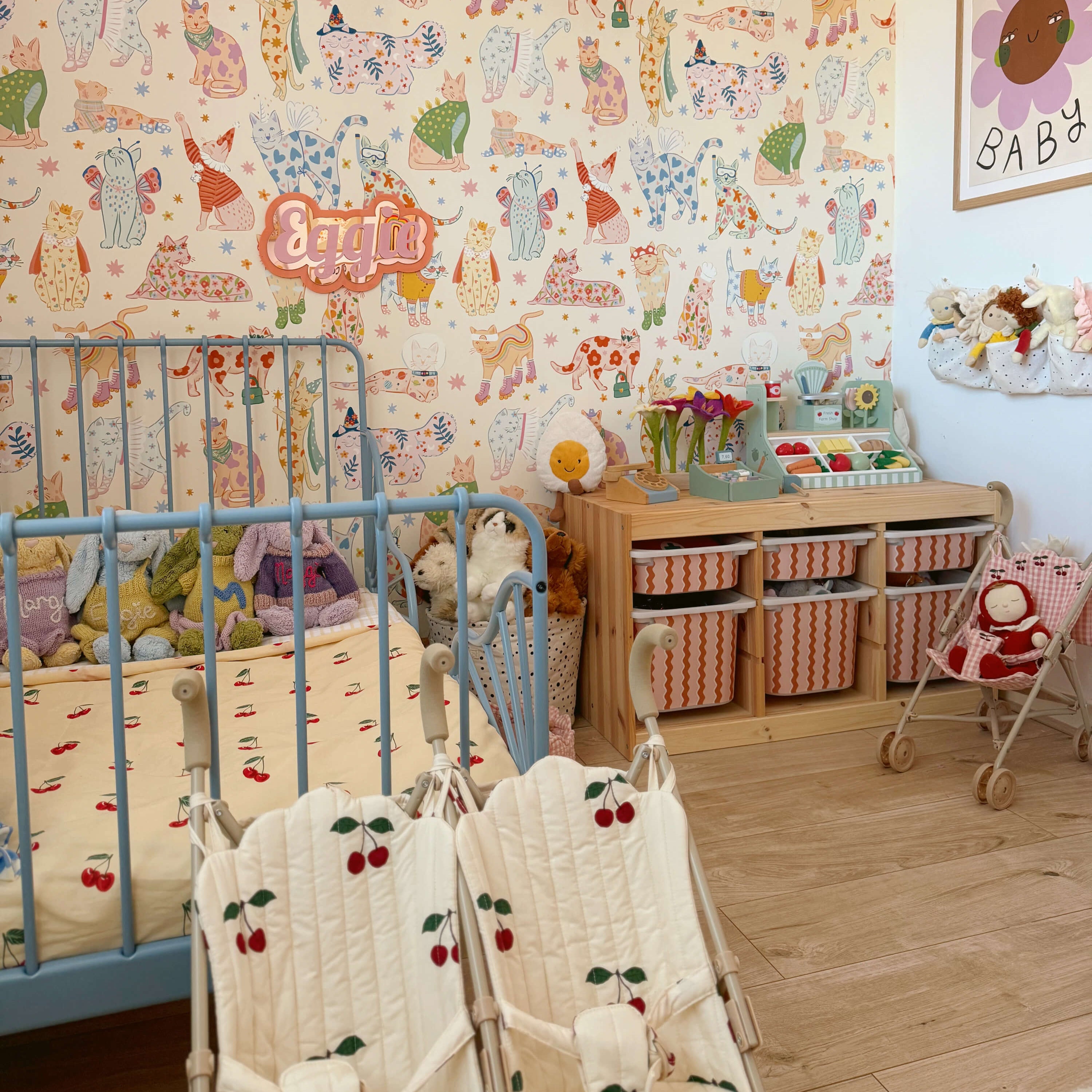 Children's room with bed, bright wallpaper, IKEA Trofast toy unit and toys