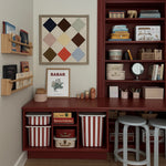 Home office with wooden desk, bookshelves, and decorative items.