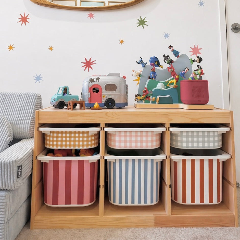 Children's room with storage bins, toys, and a mirror on the wall.
