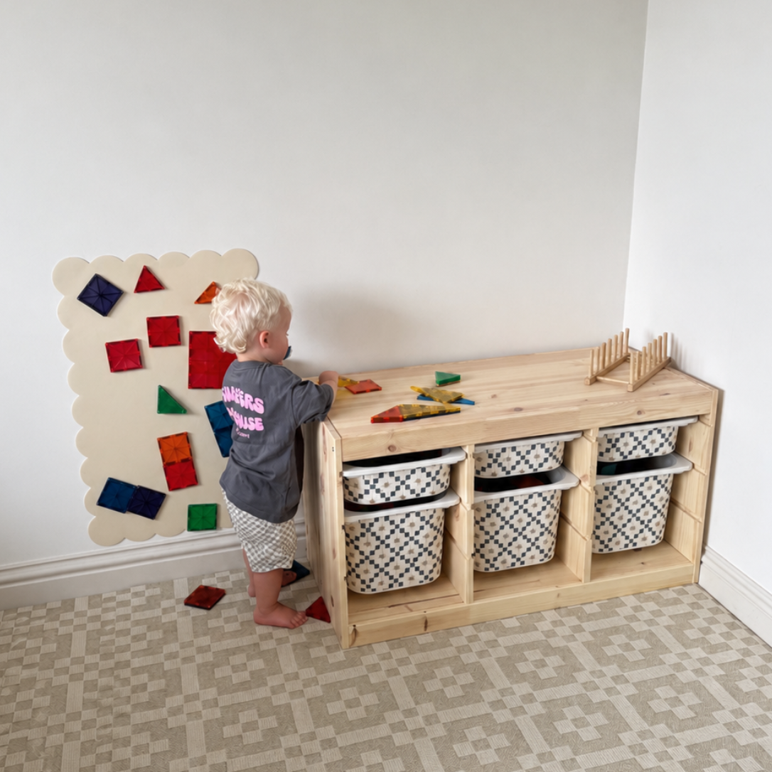 Child playing with a wooden toy set on a patterned floor.