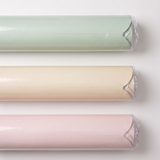 Three rolls of magnet wall decal in sage green, cream, and light pink, each wrapped in clear plastic and arranged horizontally on a white background.